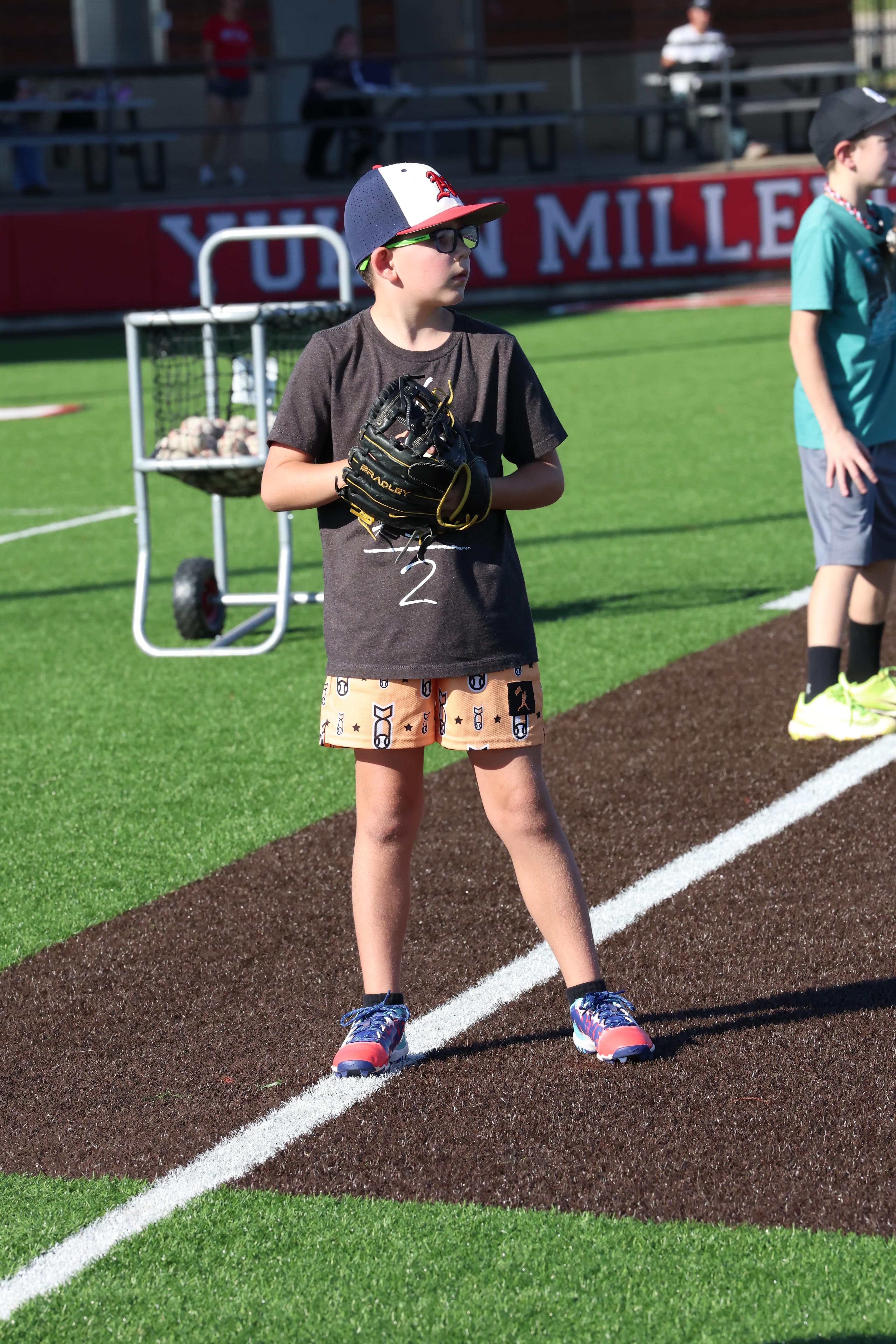 A Fall Camp camper stands ready with a glove at Miller Field