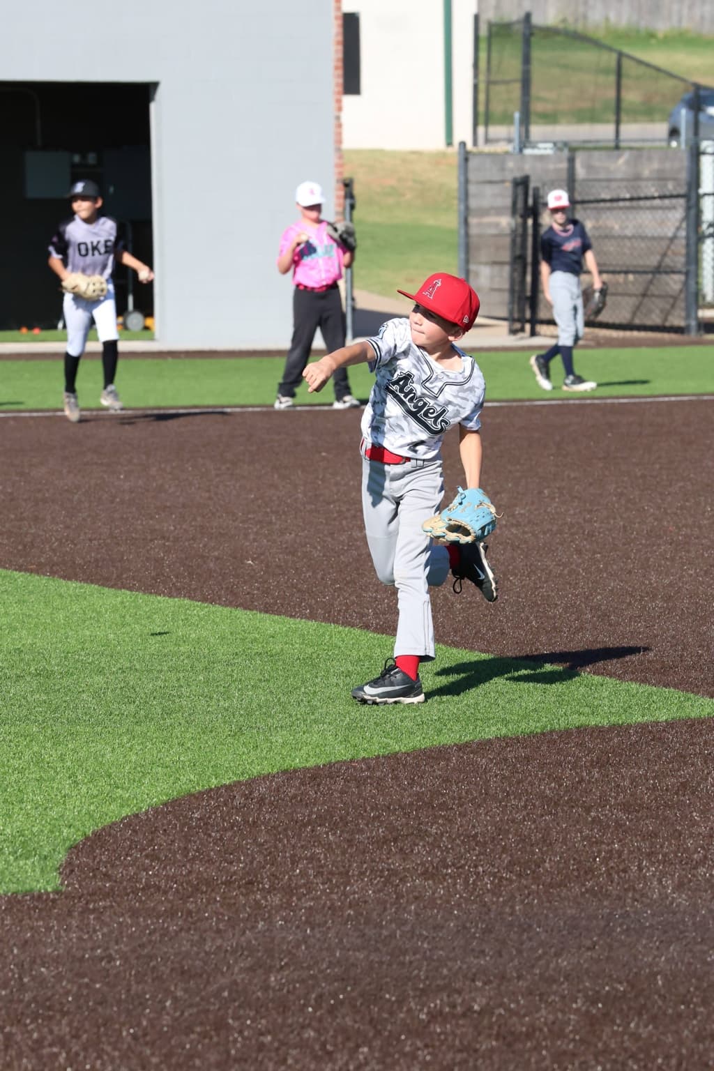 A Fall Camp camper throwing a pitch during a fielding drill