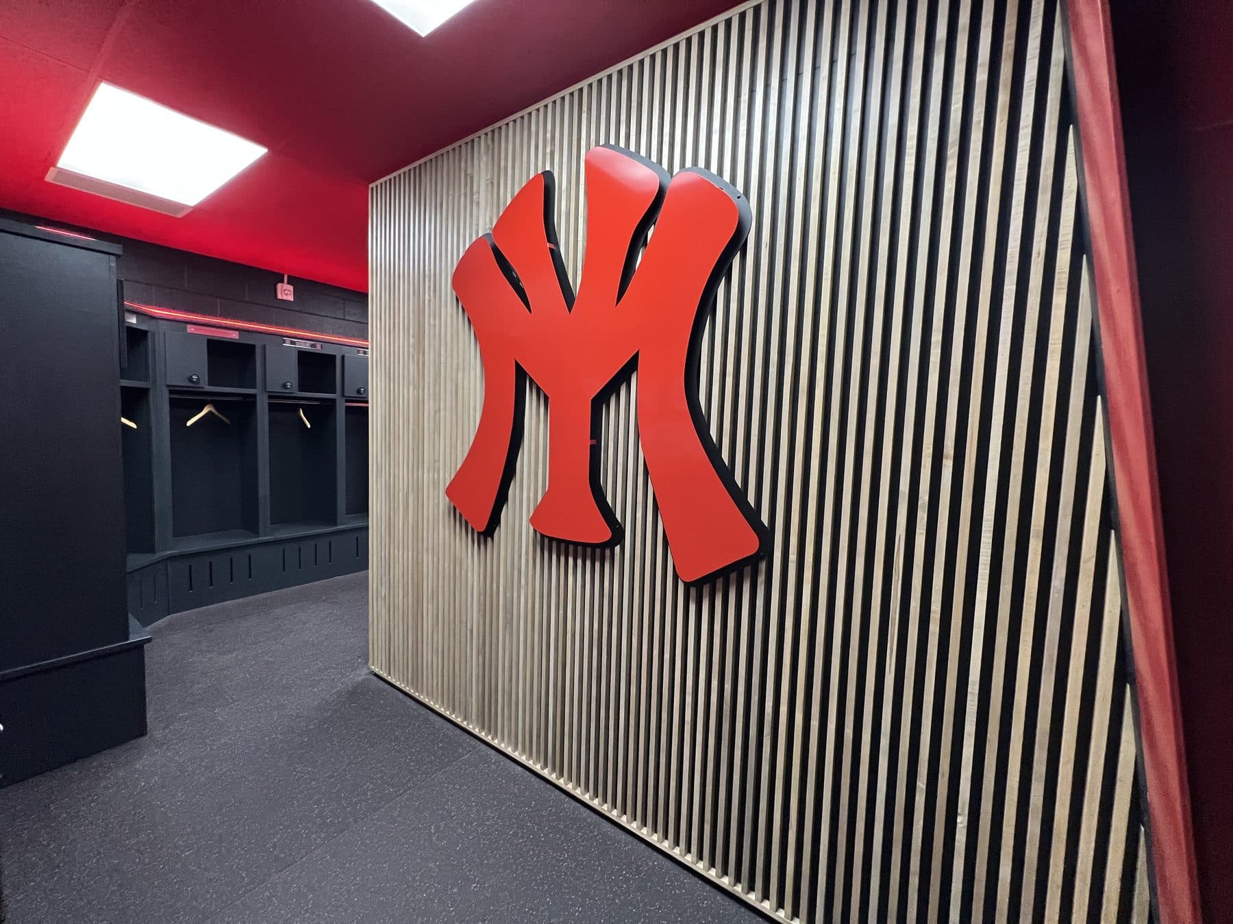 Red YM mark on the wood slat wall in the Yukon Miller clubhouse