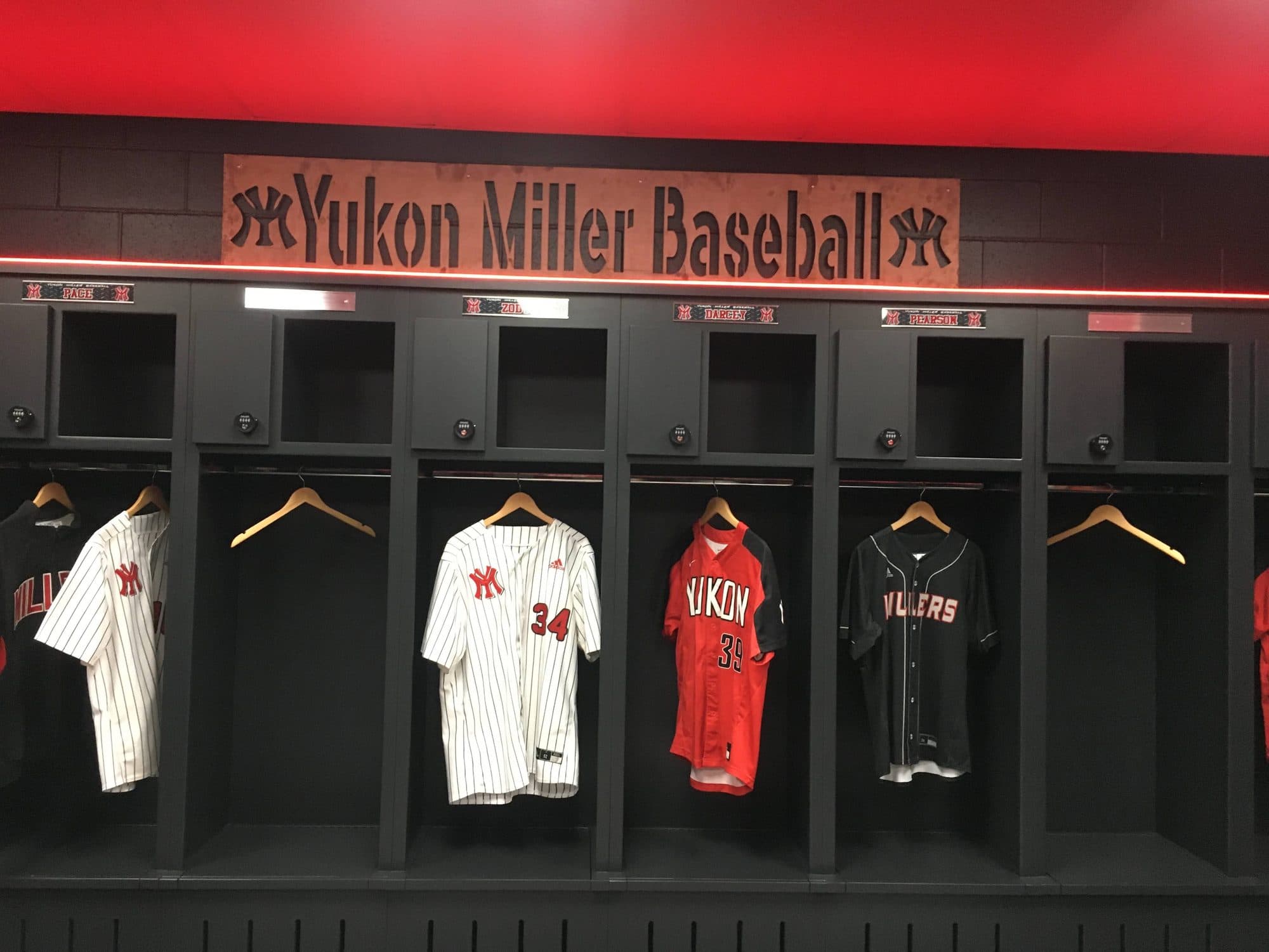 Yukon Miller Baseball lockers with home and road jerseys hanging