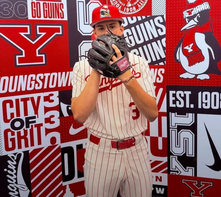 Brayden Trogdon in a Youngstown State uniform, holding a glove in front of his face