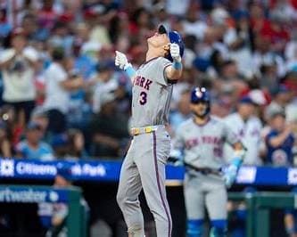 Carson Benge looking up after a play in a New York Mets road uniform