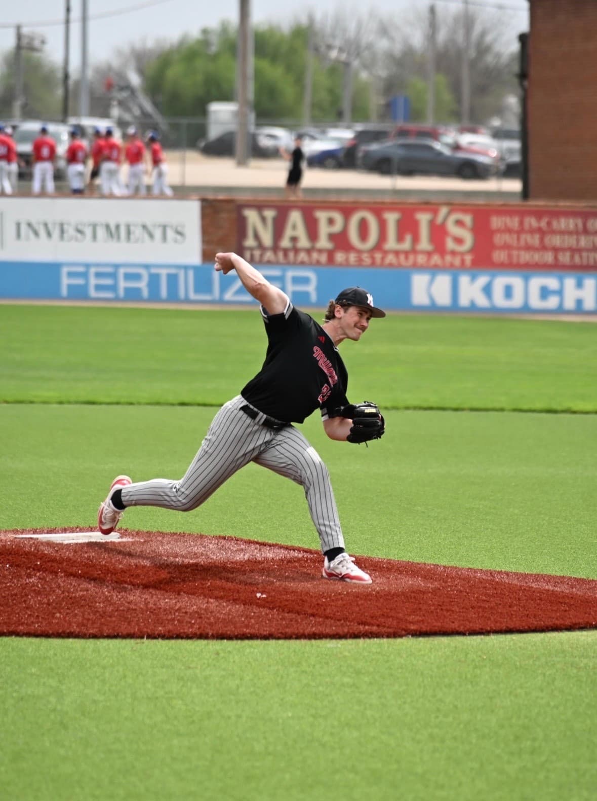 Clayton Strange delivering a pitch on the mound in a Yukon Miller uniform