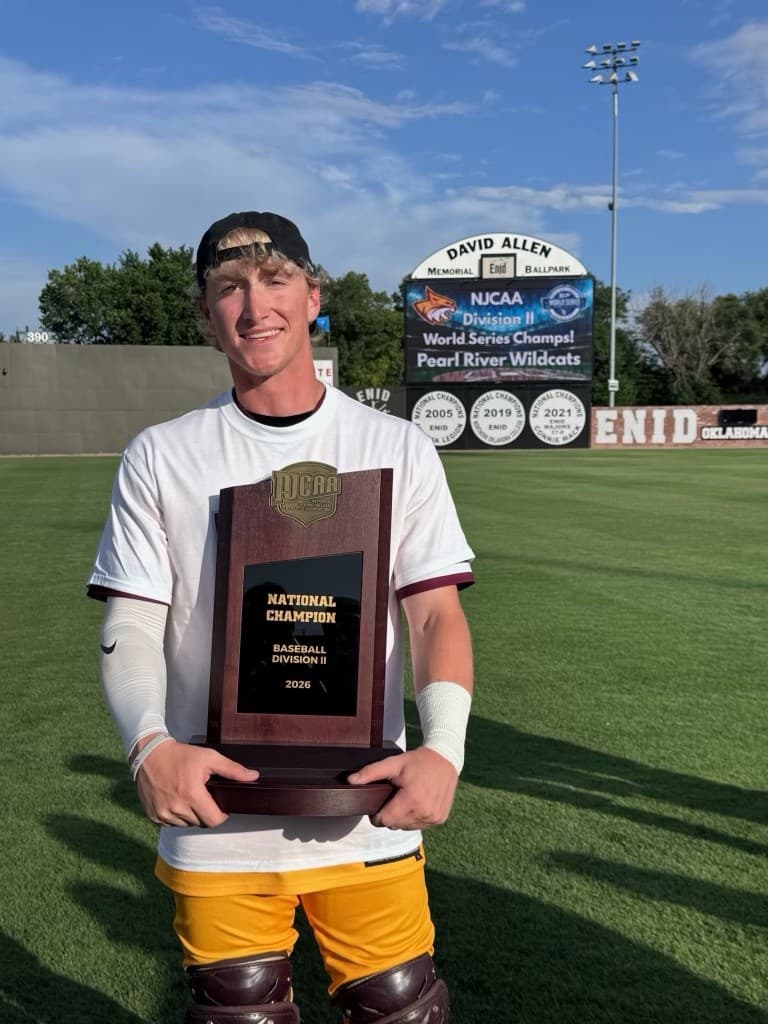 Colton Strange holding the 2026 NJCAA Division II national championship plaque in Enid