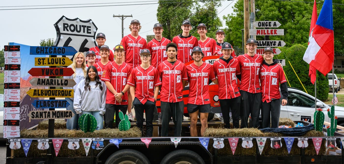 Yukon Miller Baseball players in red Yukon’s Best jerseys standing on the Czech Festival Parade float